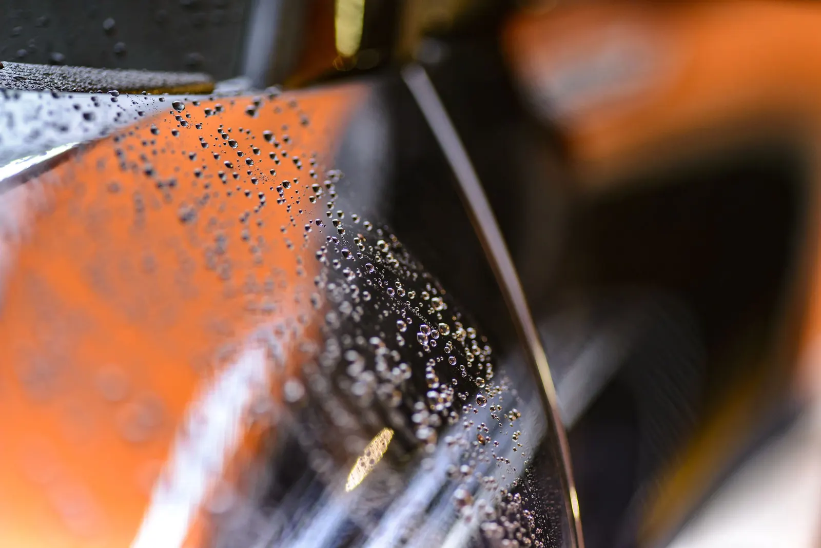 A glossy car front under shop lights